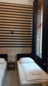 Łóżko lub łóżka w pokoju w obiekcie Aparthotel Łódź 55 Piotrkowska