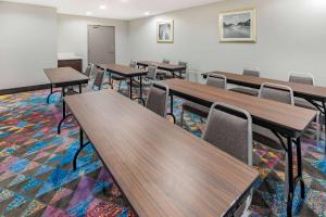 a classroom with wooden tables and chairs at La Quinta by Wyndham Houston Southwest in Houston +31 photos