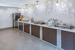 a kitchen with a long counter in a restaurant at La Quinta by Wyndham Houston Southwest in Houston