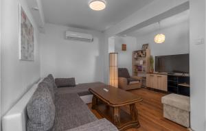 a living room with a couch and a table at 3 Bedroom Pet Friendly Home In Dramalj in Dramalj