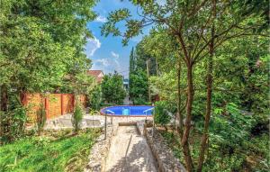 a swimming pool in a yard with trees at 3 Bedroom Pet Friendly Home In Dramalj in Dramalj