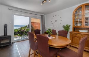 a dining room with a table and a view of the ocean at 3 Bedroom Pet Friendly Home In Dramalj in Dramalj