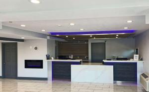 a lobby with a counter with blue lights on the ceiling at Rodeway Inn Sacramento-University Area in Sacramento