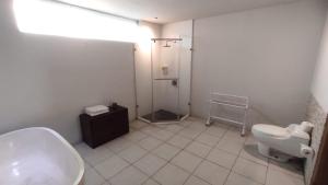 a bathroom with a sink and a shower and a toilet at The Radian Villa in Canggu