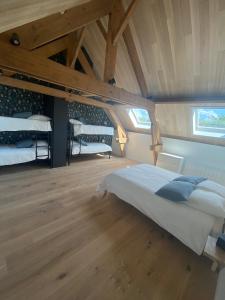 a bedroom with two bunk beds in a attic at LA GRANGE in Anzin-Saint-Aubin