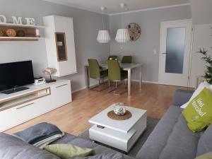 a living room with a couch and a table at 5210 Meereslust in Dahme