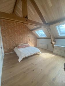 a bedroom with a bed in a attic at LA GRANGE in Anzin-Saint-Aubin