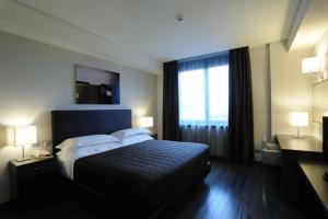 a hotel room with a bed and a large window at Park Hotel Sporting in Teramo