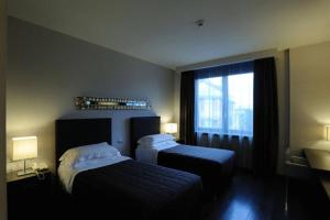 a hotel room with two beds and a window at Park Hotel Sporting in Teramo