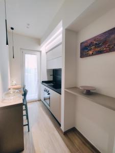 a kitchen with white cabinets and a counter top at Casa Magrè in Agrigento +22 photos