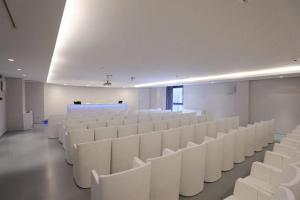 an empty room with white chairs and a white ceiling at Park Hotel Sporting in Teramo
