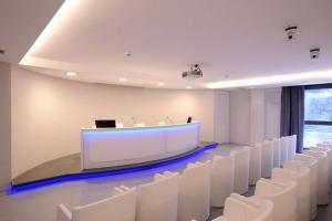 a conference room with white chairs and a stage at Park Hotel Sporting in Teramo