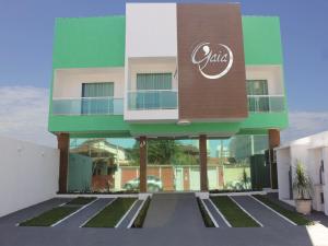 a building with a sign on the side of it at Pousada Gaia in Macaé