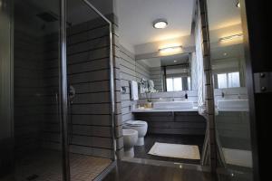 a bathroom with a shower and a toilet and a sink at Park Hotel Sporting in Teramo