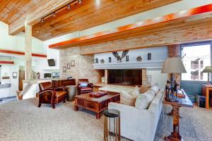 a living room with a couch and a fireplace at Mountain Chalet Snowmass in Snowmass Village