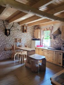 a kitchen with a table and a kitchen with a counter at Domki Białogarda 