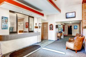 a lobby with a waiting area with chairs and a television at Mountain Chalet Snowmass in Snowmass Village