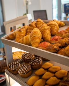 a display case with various types of bread and pastries at The 1932 Hotel & Spa Cap d'Antibes - MGallery Collection in Juan-les-Pins