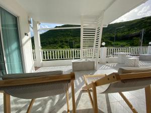 a porch with two chairs and a view of the ocean at Winnerview II - Mountain in Ko Larn