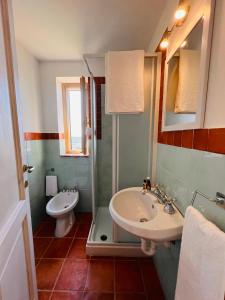 a bathroom with a sink and a toilet at La bella vista in Monte San Biagio