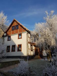a large house with trees in front of it at Bike & Sleep Weserbergland Ferienhaus in Vahlbruch