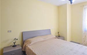 a bedroom with a bed and two night stands at Amazing Apartment In Ricadi With House Sea View in Ricadi