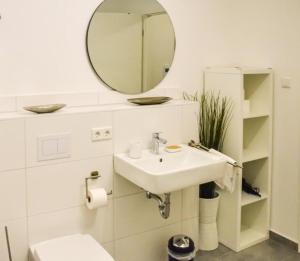 a bathroom with a sink and a mirror at StellaStudio in Hamburg +11 photos