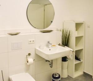 a bathroom with a sink and a mirror at StellaStudio in Hamburg