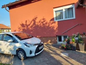 mały biały samochód zaparkowany przed domem w obiekcie Apartment My Home w mieście Varaždin