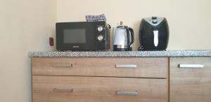 a kitchen counter with a microwave and a coffee maker at Apartment My Home in Varaždin