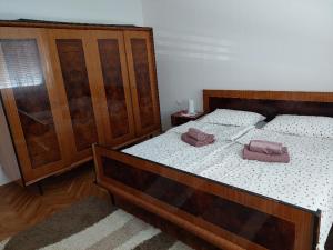 two beds in a bedroom with two towels on them at Apartment My Home in Varaždin