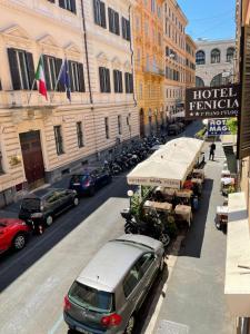 a view of a street with cars parked in front of buildings at Hotel Fenicia in Rome