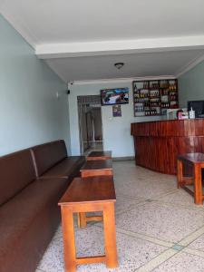 a living room with a couch and a coffee table at Kasenene Legacy Hotel in Fort Portal