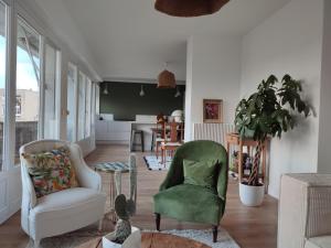 a living room with two chairs and a table at Romy in Boulogne-sur-Mer
