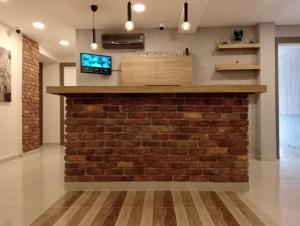 a brick wall in a living room with a fireplace at Side Leon Otel in Side