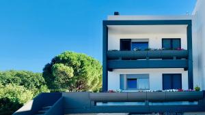 a white building with a balcony with flowers on it at Villa Bellavista in Martina Franca