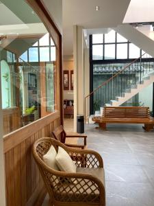 a lobby with two chairs and benches in a building at Alleyhill Phuket - Private & Cozy Boutique in Phuket