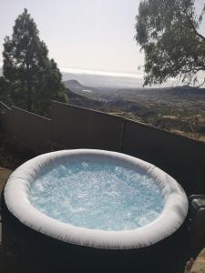 a large bath tub with blue water in it at Suite Zen y Cueva Refugio in Tenteniguada