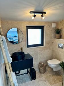 a bathroom with a sink and a toilet and a mirror at CALANQUE D'EN VAU in Cassis