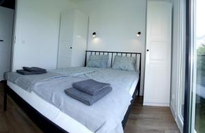 a bedroom with a bed with towels on it at Rospuda B in Supienie