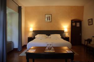 a hotel room with a bed and a table with a tray on it at Château De La Caze Piscine & Spa - Ste Enimie in Sainte-Énimie