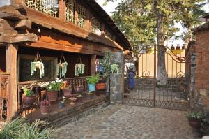a fence with a bunch of potted plants on it at Eco Hotel Ixhi in Pátzcuaro