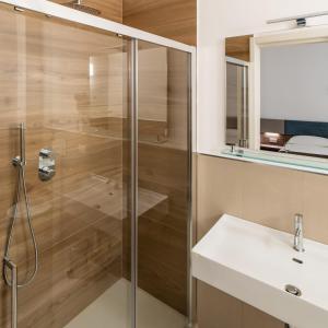 a bathroom with a glass shower and a sink at Terrazza sul Mare in Roseto degli Abruzzi +28 photos