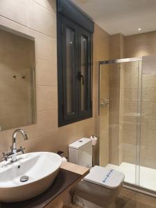 a bathroom with a sink and a toilet and a shower at Apartamento María Mendoza in Ardales