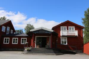 a red building with stairs in front of it at Hemavans Wärdshus in Hemavan +20 photos