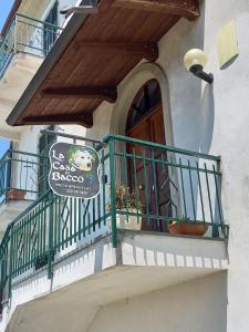 a building with a balcony with a sign on it at La Casa di Bacco B&B in Lerma