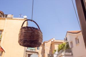 a basket hanging from the window of a building at 4711 Boutique Apartment in Sorrento
