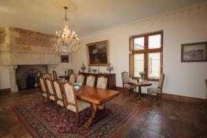 a dining room with a table and a chandelier at Domaine de La Vitrolle in Limeuil