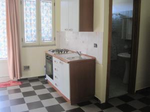 a kitchen with a sink and a stove top oven at Tenuta Innocenzi in Sanarica