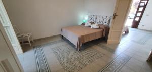a bedroom with a bed in a room at A 2 passi dal mare - grazioso trilocale a Locri in Locri